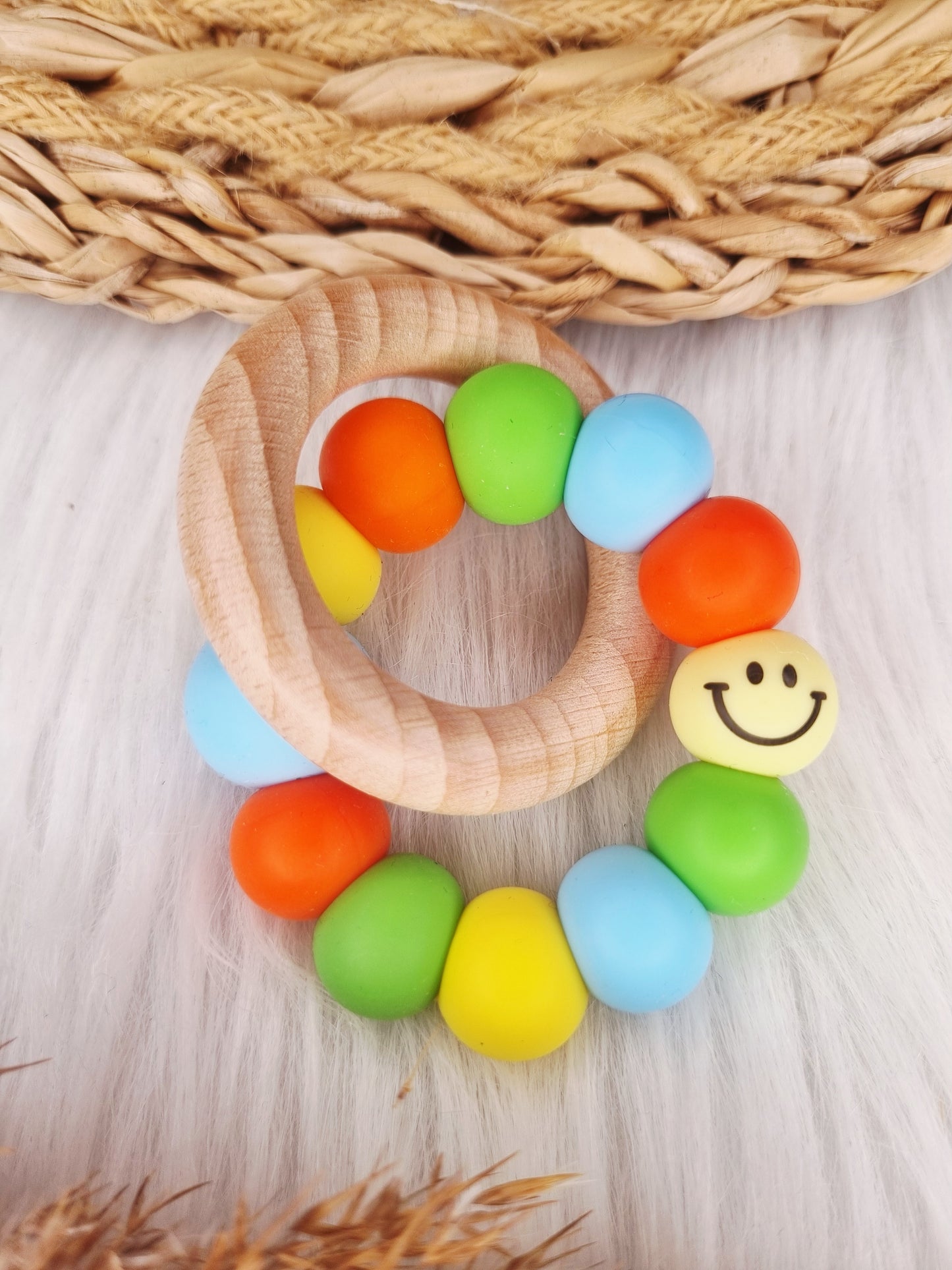 Bijtring met naam - Smiley, babyblauw, oranje, geel, groen