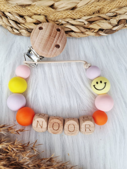 Speenkoord met naam - Smiley, babypink, geel, lila, oranje