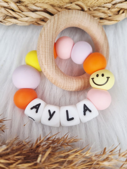 Bijtring met naam - Smiley - babypink, geel, lila, oranje