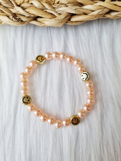 Kinderarmband - Pearl smiley goud zalmroze